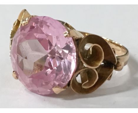 A yellow metal and pink stone ring (size J 1/2).