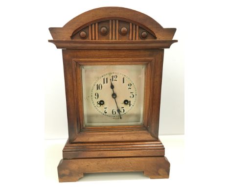 An early 20th century oak cased chiming mantle clock.