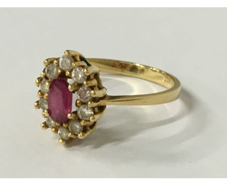 An 18 carat gold ruby and diamond set ring (size O).