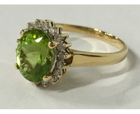 An 18 carat gold Peridot and diamond set cluster ring (size T).