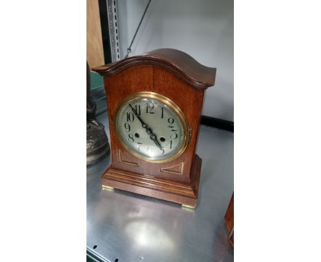 An early 20th century oak cased mantle clock with chiming movement.