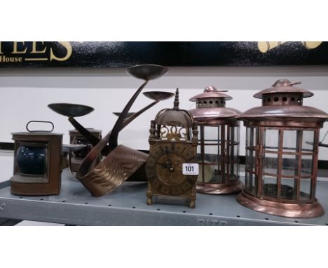 A brass lantern clock (battery operated) together with various ships and other lanterns and a modernist candelabra.