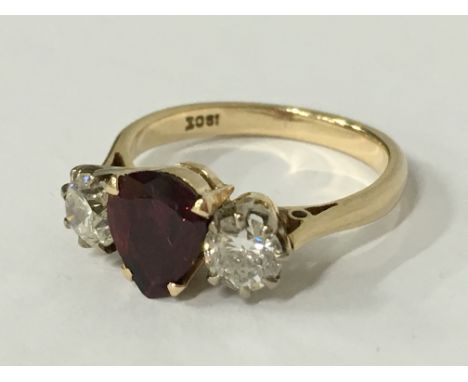 An 18 carat gold ruby and diamond set ring, the central teardrop ruby approximately 0.80 carat flanked with two diamonds, eac