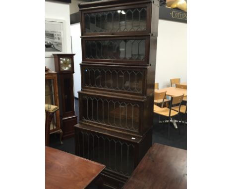 A large leaded glass waterfall fronted Globe Wernicke bookcase with solid drawer below.