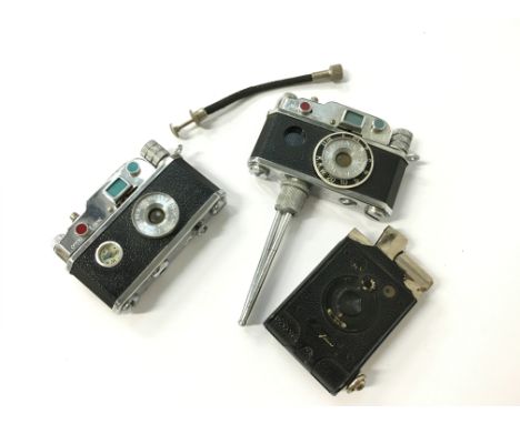 A novelty KKW camera cigarette lighter, together with two others.