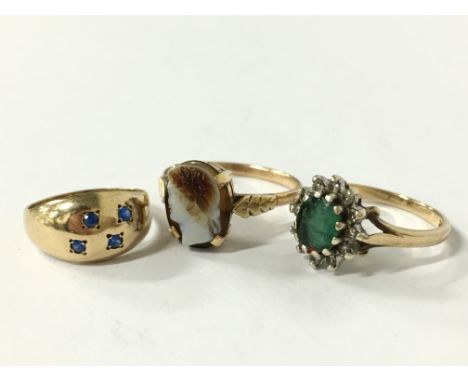 A 9 carat gold emerald and diamond set ring (size M) together with a 9 carat gold blue stone Gypsy set ring (size G) and a 9 