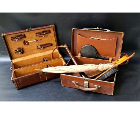 SMALL VINTAGE LEATHER CASEcontaining a wooden truncheon, clothes brushes, a parasol and handheld mirror; together with leathe