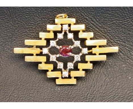 UNUSUAL DIAMOND AND RUBY PENDANTthe central oval cut ruby approximately 0.4cts in pierced twelve diamond surround totalling a