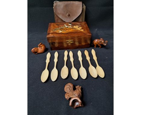 MIXED LOT OF COLLECTABLEScomprising an Indian teak inlaid box, seven shaped bone spoons, carved elephant and two cockerel net