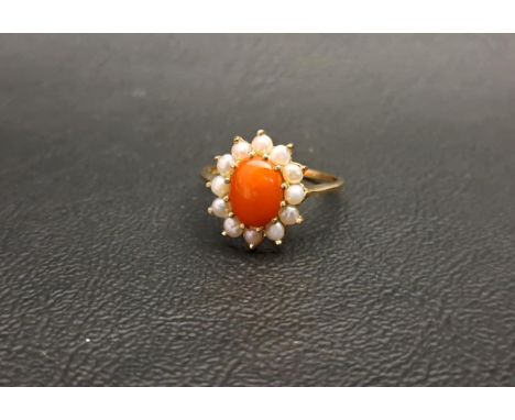 CORAL AND SEED PEARL CLUSTER RINGthe central oval cabochon coral in twelve pearl surround, on nine carat gold shank, ring siz