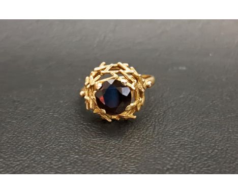 VINTAGE 1970s GARNET SET RINGthe round cut garnet approximately 2cts in pierced and textured basket effect setting, on nine c