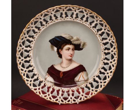 A Continental porcelain shaped circular charger, painted and printed with a portrait of a young lady wearing a feathered hat,