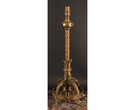 A Neo Gothic brass and copper table lamp, in the manner of William Burgess, the circular base pierced with tracery, each scro