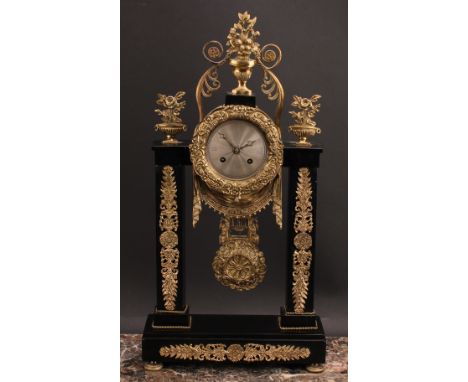 A French Empire design gilt metal mounted black slate portico clock, 8cm circular silvered dial, twin winding holes, eight da