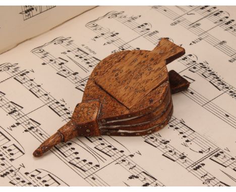 A 19th century novelty treen snuff box, as bellows, decorated with brass pin work, sliding cover, 11cm long 