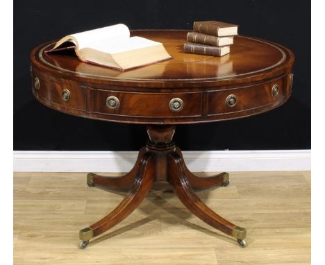 A Post-Regency mahogany drum table or rent table, circular top with inset tooled and gilt leather writing surface, above four