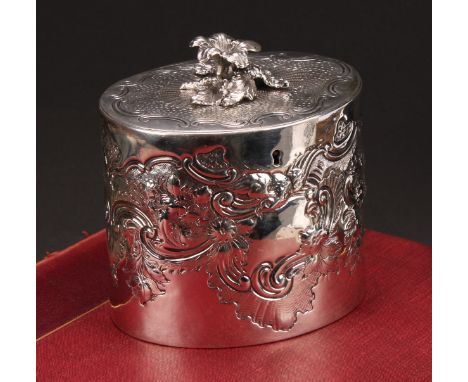 A George III oval tea caddy, chased with birds, flowers and scrolling leaves, flush-hinged cover with flower finial, 11.5cm w