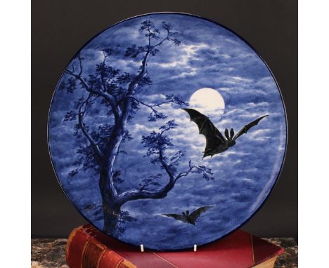A Royal Worcester Aesthetic Movement circular charger, painted with bats against a moonlit sky, in shades of black and blue, 