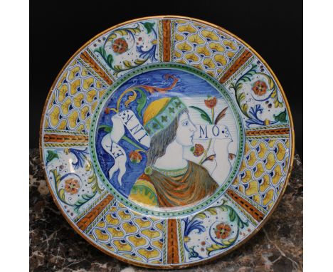 An Italian maiolica circular charger, painted in the Renaissance taste with a bust-length portrait of a nobleman, within a co