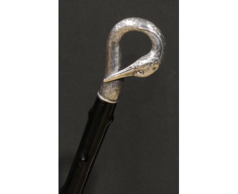 An Austrian silver mounted novelty walking stick, the handle as the head of a heron, with neck curled, ruby eyes, ebonised ca