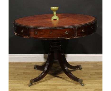 A Post-Regency mahogany drum table, circular top with reeded edge and inset tooled and gilt leather writing surface, above th