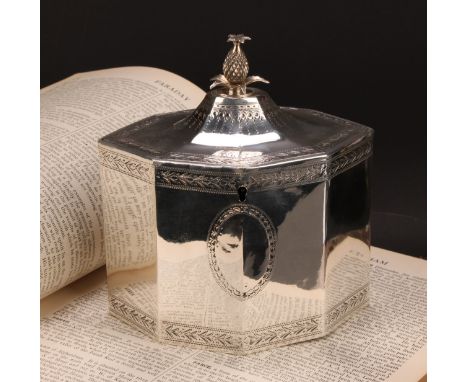 A George III silver octagonal tea caddy, flush-hinged cover with pine apple finial, bright-cut engraved borders and cartouche