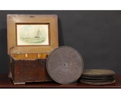 A 19th century walnut symphonion, Original 48D., horizontal mechanism playing 28cm discs, 43cm wide, c.1890; various discs 