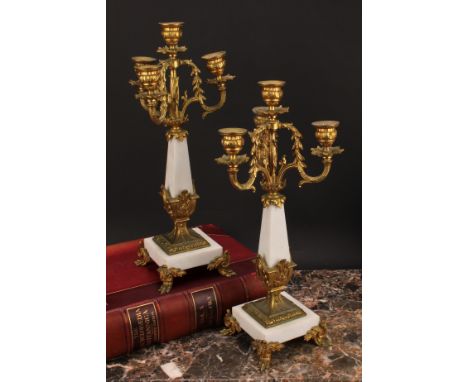 A pair or Louis XVI style gilt metal mounted three branch four light candelabrum, 38cm high 