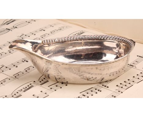 A George III silver pap boat, gadrooned border, 13cm long, London 1801, 60g 