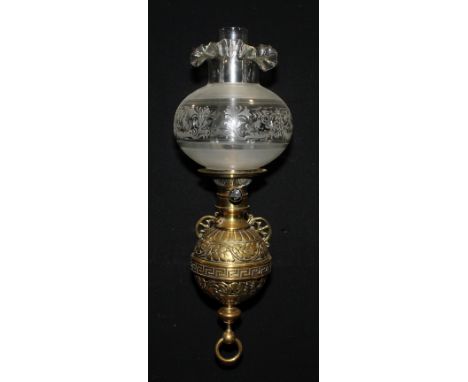 A 19th century brass wall mounted globular oil lamp, cast with foliate scrolls and Greek key border, lift out font, Matador 2