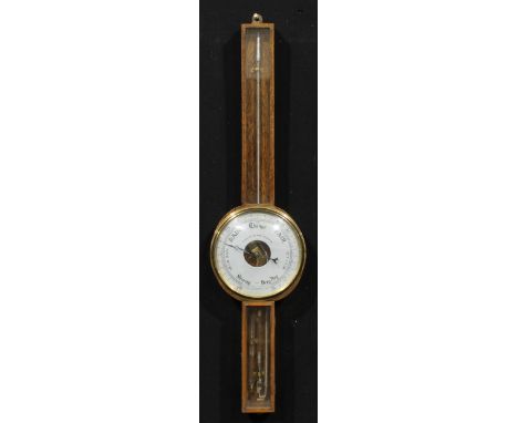 An early to mid 20th century oak wheel barometer, 19.5cm circular register inscribed DEMONSTRATION WHEEL BAROMETER., the case