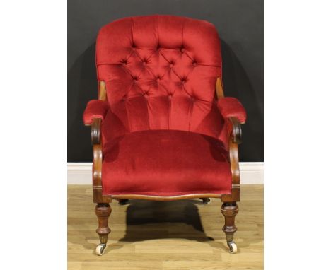 A Victorian mahogany library chair, stuffed-over upholstery, scroll hand rests, turned forelegs, ceramic casters, 92cm high, 