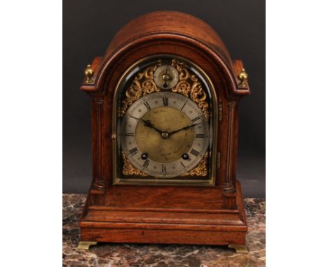 An early 20th century oak bracket-form mantel clock, 14cm arched brass dial with silvered chapter ring inscribed G. PARKIN NE