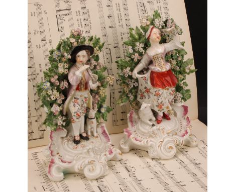 A pair of Derby patch mark figures, Shepherd and Shepherdess, he standing playing a horn with a dog at his side, she dancing 