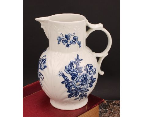 A rare Worcester cabbage leaf jug, moulded with overlapping leaves, bearded mask spout, decorated in underglaze blue with hea
