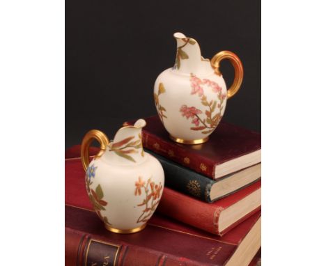 A pair Royal Worcester flat back jugs, decorated in the Aesthetic manner with floral sprays in muted tones picked out in gilt