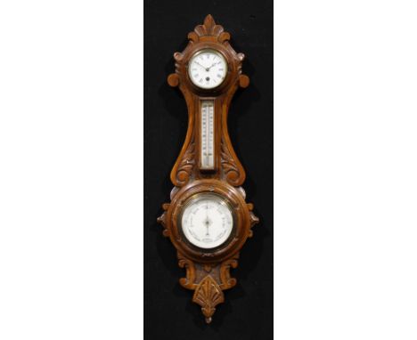 A late Victorian oak wheel weather station timepiece, 8cm circular clock dial inscribed with Roman numerals, above a thermome