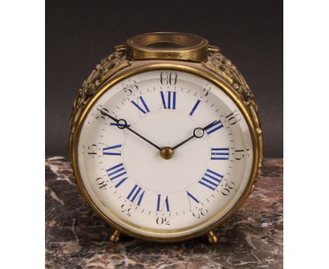 An early 20th century French brass circular carriage type timepiece, 9cm enamel clock dial inscribed with Roman and subsidiar