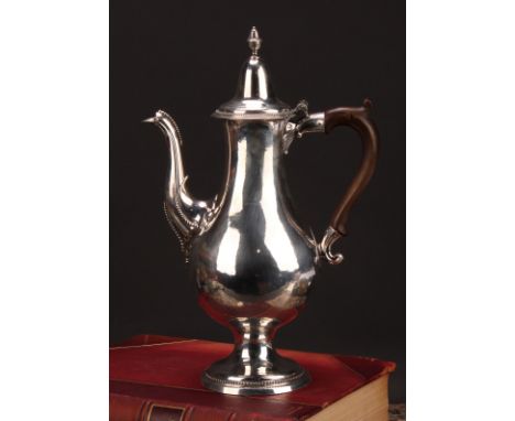 A George III provincial silver baluster coffee pot, hinged lofty domed cover with acorn finial, scroll-capped fruitwood handl