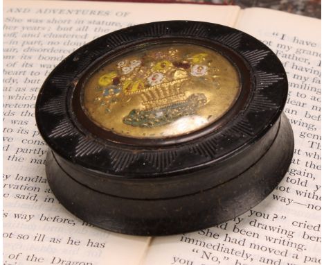 An early 19th century pressed horn waisted circular snuff box, the push-fitting cover decorated in polychrome and gilt with a