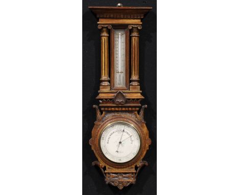 A late Victorian oak architectural wheel barometer, 15.5cm circular silvered register inscribed T. ARMSTRONG &amp; BRO 88 &am