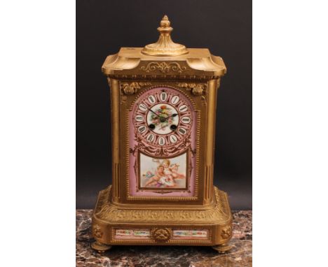 A late 19th century French spelter and porcelain mantel clock, the panel inscribed with Roman numerals and decorated with put