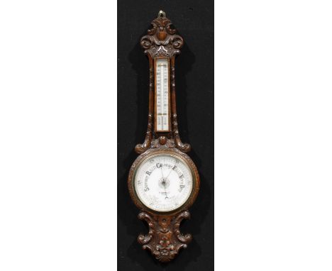 A late Victorian oak wheel barometer, 18.5cm circular register inscribed F. DARTON & CO LONDON, the case carved with acanthus
