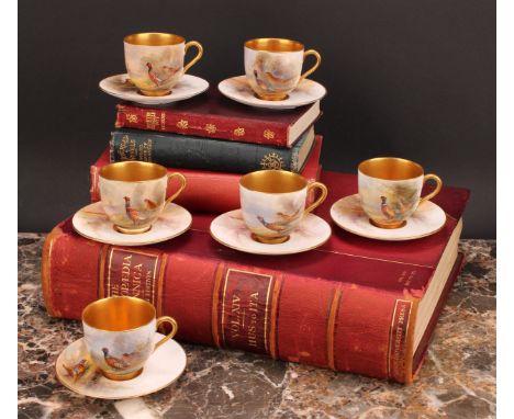 A set of six Royal Worcester coffee cups and saucers, painted by James Stinton, signed, with pheasants, burnished gilt border