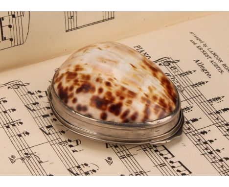 A George III silver mounted cowrie shell snuff box, hinged cover to base, gilt interior, 7.5cm wide, indistinctly marked, c.1