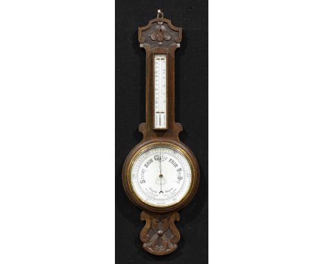 An early 20th century oak wheel barometer, 19cm circular register inscribed LANCASTER &amp; THORPE LTD THE OPTICIANS, the cas