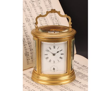 A late 19th century gilt brass oval repeating alarum carriage clock, 7cm enamel dial with Roman numerals above an alarm setti