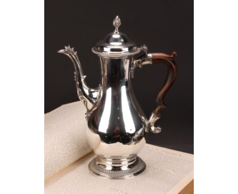 A George III silver baluster coffee pot, quite plain, hinged domed cover with wrythen finial, scroll-capped fruitwood handle,