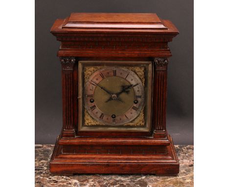 An early 20th century oak architectural bracket-form mantel clock, 15cm square brass dial with silvered chapter ring inscribe