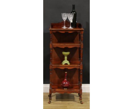 A late Victorian walnut four-tier whatnot, shaped three-quarter gallery, ring-turned supports, ceramic casters, 103cm high, 4